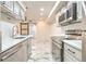 Updated kitchen featuring white shaker cabinets, stainless steel appliances, and marble-look tile floor at 9100 Dr Martin Luther King Jr N St # 1706, St Petersburg, FL 33702