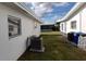 Side exterior showcasing the home's air conditioning unit and lawn at 9350 Mainlands W Blvd, Pinellas Park, FL 33782