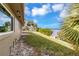 Backyard view of house, green grass, and water at 945 Bayshore Dr, Tarpon Springs, FL 34689