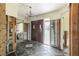 Foyer with double doors, a chandelier, and slate tile flooring. The room shows signs of ongoing renovation at 945 Bayshore Dr, Tarpon Springs, FL 34689