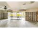 Room with block walls, ceiling fan, and sliding glass doors with water view at 945 Bayshore Dr, Tarpon Springs, FL 34689