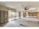 Open room with sliding glass doors, block walls, and ceiling fan at 945 Bayshore Dr, Tarpon Springs, FL 34689