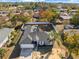 Aerial view of a house with a fenced backyard and surrounding trees at 11224 Allwood St, Spring Hill, FL 34609