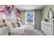Bedroom with a unique accent wall, white bedding, and matching furniture at 1148 Great Ibis Dr, Ruskin, FL 33570