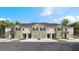 Modern townhomes with garages, landscaping, and palm trees at 1148 Great Ibis Dr, Ruskin, FL 33570