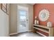 Entryway with an orange accent wall, console table, and decor at 1150 Great Ibis Dr, Ruskin, FL 33570