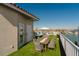Waterfront roof deck offers panoramic views, dining and lounge seating, and white metal railings at 140 Brightwater Dr # 6, Clearwater Beach, FL 33767