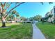 Curved walkway through a lush green community space at 14130 Rosemary Ln # 5301, Largo, FL 33774