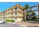 Condo building exterior with walkway, parking and lush landscaping at 14130 Rosemary Ln # 5301, Largo, FL 33774