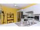 Kitchen with double sink, stainless steel appliances, and yellow walls at 14130 Rosemary Ln # 5301, Largo, FL 33774