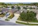 Aerial view of house with solar panels, American flag, and neighborhood at 17766 Garsalaso Cir, Brooksville, FL 34604