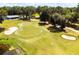 Aerial view of golf course with green, sand traps, and clubhouse at 17766 Garsalaso Cir, Brooksville, FL 34604