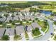 Aerial view of a neighborhood with houses, a lake and golf course at 17766 Garsalaso Cir, Brooksville, FL 34604