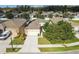 Aerial view showing house with solar panels and American flag at 17766 Garsalaso Cir, Brooksville, FL 34604