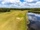 Aerial view of golf course with water features and lush greens at 17766 Garsalaso Cir, Brooksville, FL 34604