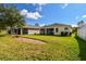 Home with covered patio, fenced backyard, and grassy area at 17766 Garsalaso Cir, Brooksville, FL 34604