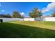 Spacious backyard with grassy area, privacy fence, and mature tree at 17766 Garsalaso Cir, Brooksville, FL 34604