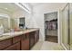 Double vanity bathroom with granite countertop and large walk-in shower at 17766 Garsalaso Cir, Brooksville, FL 34604