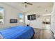 Bedroom with wood floors, ceiling fan, and blue bedding at 17766 Garsalaso Cir, Brooksville, FL 34604