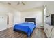 Bedroom with wood floors, en-suite bathroom access and blue bedding at 17766 Garsalaso Cir, Brooksville, FL 34604