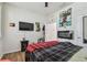 Bedroom with wood floors, electric fireplace, and large bed at 17766 Garsalaso Cir, Brooksville, FL 34604