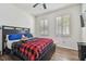 Bedroom with wood floors, ceiling fan, and a red blanket at 17766 Garsalaso Cir, Brooksville, FL 34604