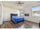 Bedroom with wood floors, electric fireplace, and blue comforter at 17766 Garsalaso Cir, Brooksville, FL 34604