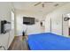 Bright bedroom with a blue comforter and mounted TV at 17766 Garsalaso Cir, Brooksville, FL 34604