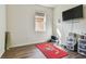 Bright bedroom with wood floors, window, and TV at 17766 Garsalaso Cir, Brooksville, FL 34604