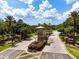 Hernando Oaks community entrance with brick pillars and lush landscaping at 17766 Garsalaso Cir, Brooksville, FL 34604