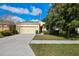 Single-story home with attached garage and landscaped lawn at 17766 Garsalaso Cir, Brooksville, FL 34604