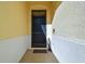Dark wood front door with storm door and entry mat at 17766 Garsalaso Cir, Brooksville, FL 34604