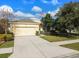 House front with two-car garage and American flag at 17766 Garsalaso Cir, Brooksville, FL 34604