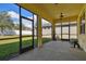 Screened porch with ceiling fan and backyard view at 17766 Garsalaso Cir, Brooksville, FL 34604