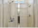 Large walk-in shower with glass enclosure and tiled walls at 17766 Garsalaso Cir, Brooksville, FL 34604