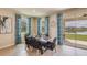 Bright dining area with a wooden table and seating for six, overlooking a lake at 18228 Metado Dr, Lakewood Ranch, FL 34211