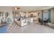 Open living area with white sofa, blue accents, and a view to the kitchen and dining areas at 18228 Metado Dr, Lakewood Ranch, FL 34211