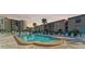 Community pool with plenty of chairs and shade for residents to enjoy at 19725 Gulf Blvd # 10, Indian Shores, FL 33785
