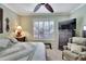 Main bedroom with king-size bed, ceiling fan, and a view of the backyard at 204 Mystic Falls Dr, Apollo Beach, FL 33572