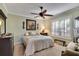 Comfortable bedroom with a ceiling fan and large windows at 204 Mystic Falls Dr, Apollo Beach, FL 33572