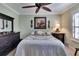 Main bedroom with a king bed, ceiling fan, and ample closet space at 204 Mystic Falls Dr, Apollo Beach, FL 33572