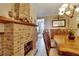 Dining room with wood table and brick fireplace at 204 Mystic Falls Dr, Apollo Beach, FL 33572