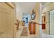 View down hallway with wood console table at 204 Mystic Falls Dr, Apollo Beach, FL 33572
