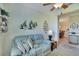 Home office with light blue walls, seating area, and window with shutters at 204 Mystic Falls Dr, Apollo Beach, FL 33572