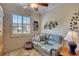 Home office with light blue walls, seating area, and window with shutters at 204 Mystic Falls Dr, Apollo Beach, FL 33572