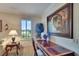 Bright home office with built-in desk and a large framed painting at 204 Mystic Falls Dr, Apollo Beach, FL 33572