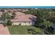 Back of house showing exterior, lawn, and palm trees at 204 Mystic Falls Dr, Apollo Beach, FL 33572