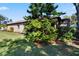 Side view of house exterior with manicured lawn and tree at 204 Mystic Falls Dr, Apollo Beach, FL 33572