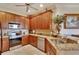 Spacious kitchen with granite countertops, stainless steel appliances, and wood cabinets at 204 Mystic Falls Dr, Apollo Beach, FL 33572