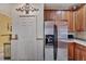 Kitchen with stainless steel refrigerator and wood cabinets at 204 Mystic Falls Dr, Apollo Beach, FL 33572
